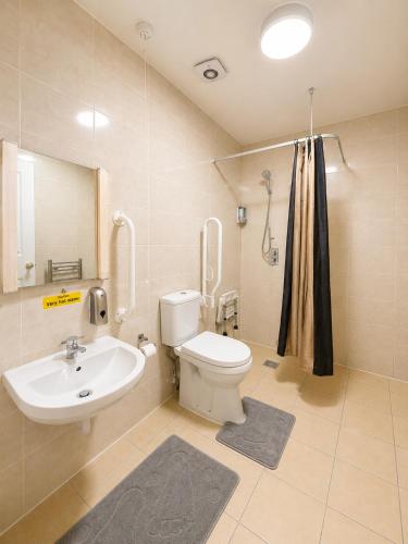 a bathroom with a white toilet and a sink at The Malik - An Art Deco Hotel in Birmingham