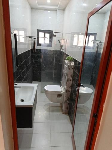 a bathroom with a toilet and a sink at Bbimo in Dakar