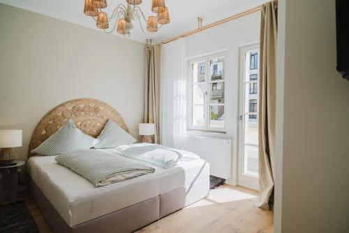 a bedroom with a white bed and a window at Boho - Suites I BRIGHT-Collection in Koblenz