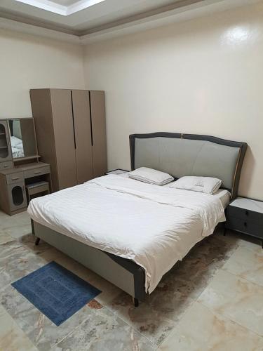 a bedroom with a large bed with white sheets at Bbimo in Dakar