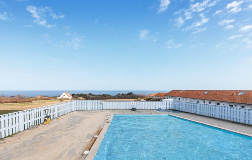 a swimming pool on the deck of a house at Pet Friendly Apartment In Allinge in Allinge
