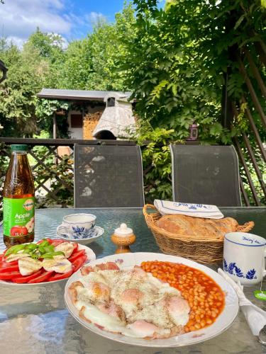 a table with plates of food and a bottle of beer at Vila Anička in Týnec nad Sázavou