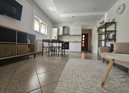 a large living room with a couch and a table at Apartma Sofiora in Dekani