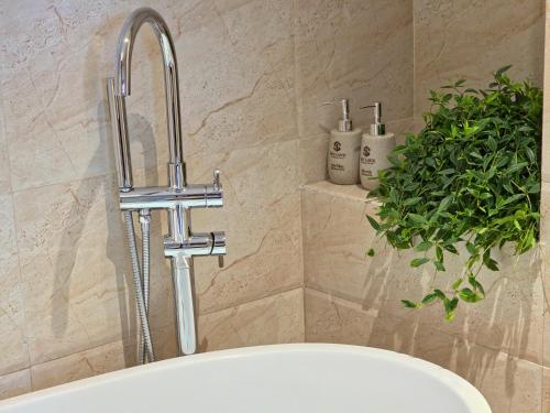 a sink with a faucet in a bathroom at Sky Love Hotel - Trâu Qùy in Thạch Cầu
