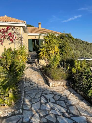a stone walkway in front of a house at villa amouso in Évyiros