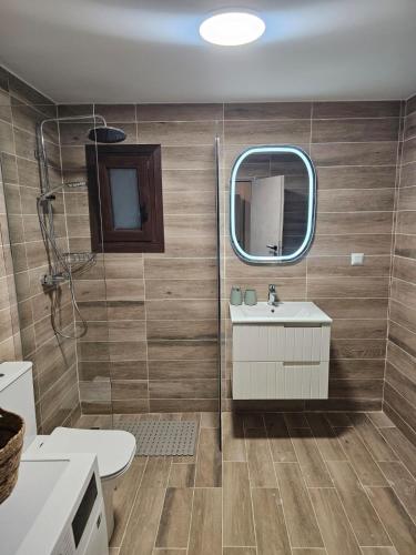 a bathroom with a sink and a mirror at Stay In Zia in Asfendioú