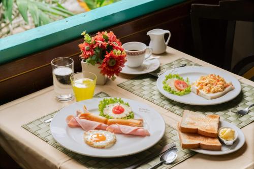 a table with two plates of breakfast food on it at Le Palace hotel krabi in Ban Khlong Haeng