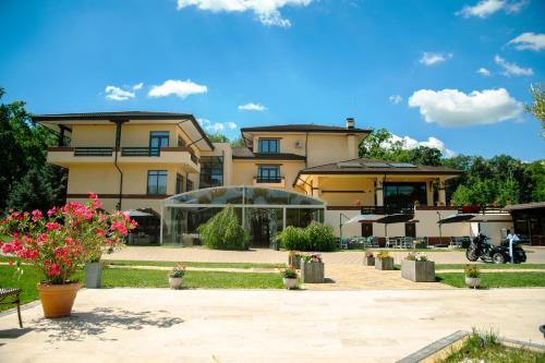 a large building with flowers in front of it at Curtea Domneasca in Vaslui