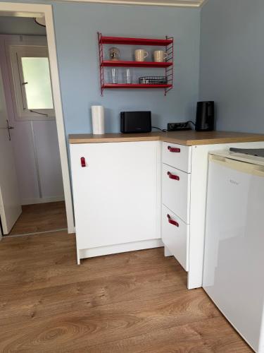 a kitchen with white cabinets and a counter top at Finnenhaus 7 in Lübeck