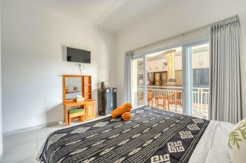 a bedroom with a teddy bear sitting on a bed at narayuka house in Seminyak