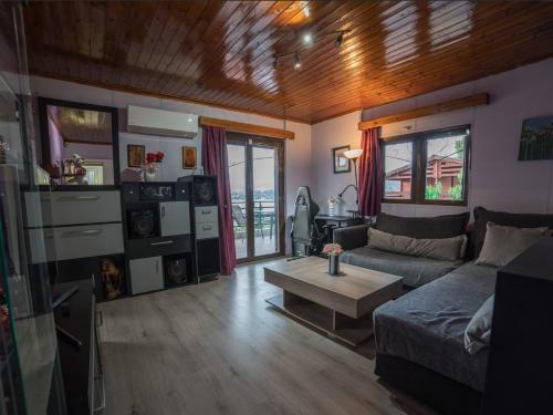 a living room with a couch and a table at Beutiful view Cosy House with Starlink internet in Salamina
