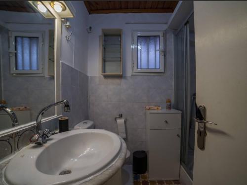 a white bathroom with a sink and a shower at Beutiful view Cosy House with Starlink internet in Salamina