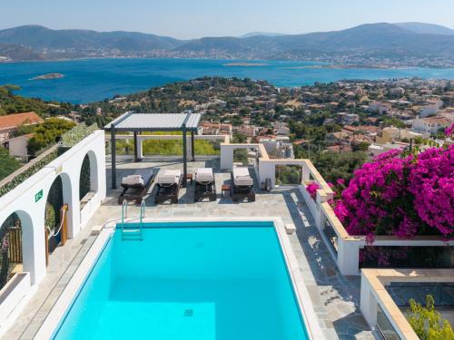a villa with a swimming pool and a view at ILIOS COVE by A&D Properties in Porto Rafti