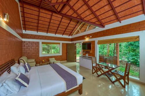a bedroom with a large bed in a room at Coffee Grove Resort in Chikmagalūr