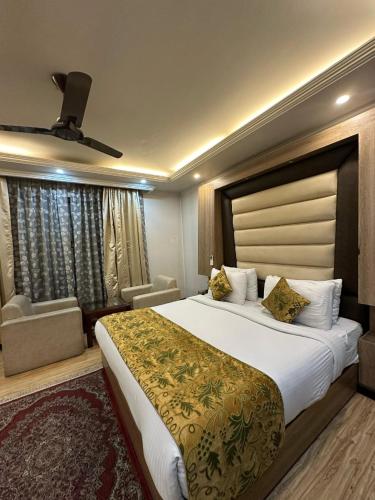 a hotel room with a large bed and a window at HOTEL ROYAL MILAD in Srinagar