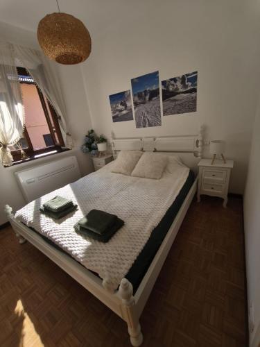 a bedroom with a bed with two towels on it at Apartament BARBARA in Branzi