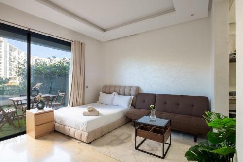 a bedroom with a bed and a couch at TT holidays Prestigia Hay Riad-Pool in Rabat