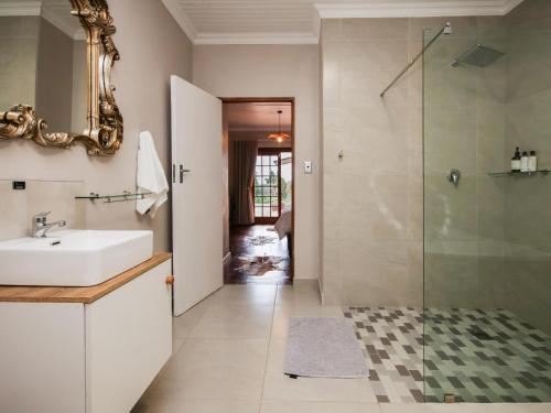 a bathroom with a sink and a shower at Swartklip Game Lodge in Riversdale