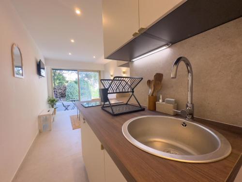 a bathroom with a large sink in a kitchen at Sublime apartment - Beachfront in Saint-Laurent-du-Var
