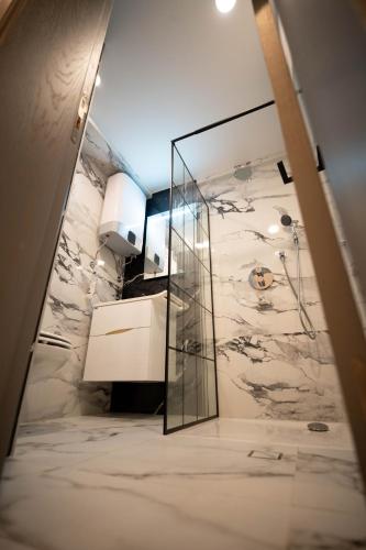 a bathroom with a sink and a mirror at Vivora Residence in Radovici