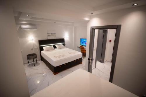 a bedroom with a bed and a walk in shower at Vivora Residence in Radovici