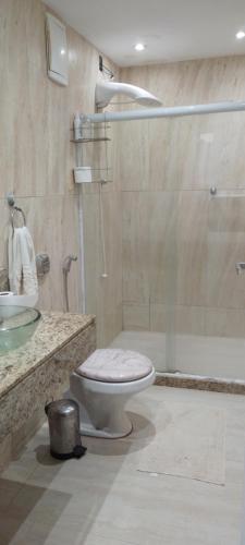a bathroom with a toilet and a sink and a shower at Yeshua - Casa da Claudia 8 in Ilha de Guaratiba