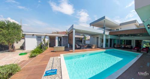 a house with a swimming pool in front of a house at Villa Vie Luxury Retreat in Blagaj