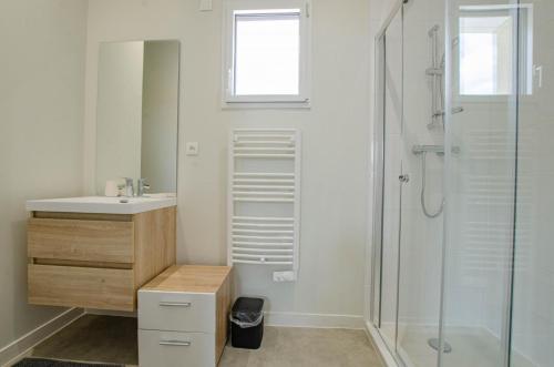 a white bathroom with a sink and a shower at Numéro 1 in Morvilliers