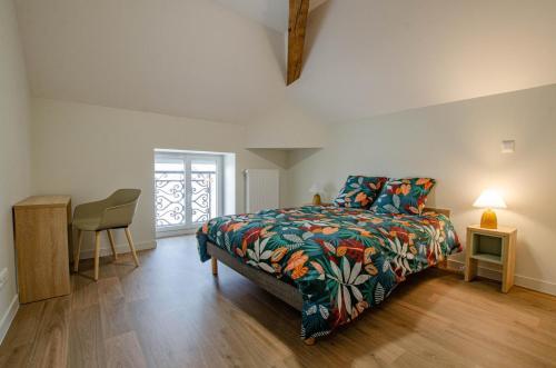 a bedroom with a bed and a table and a chair at Numéro 2 in Morvilliers