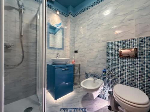 a bathroom with a toilet and a sink and a shower at Settimo Cielo in Grosio