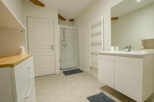 a white bathroom with a sink and a shower at Numéro 2 in Morvilliers