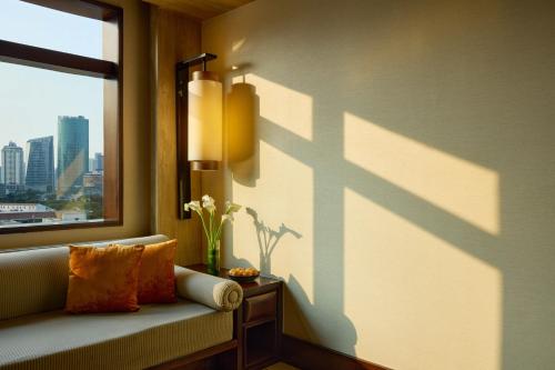 a window seat in a room with a view of a city at Gran Meliá Jakarta in Jakarta