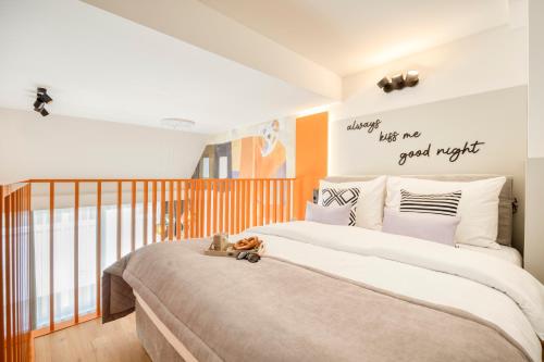 a bedroom with a large bed with a teddy bear on it at lyf Schönbrunn Vienna in Vienna