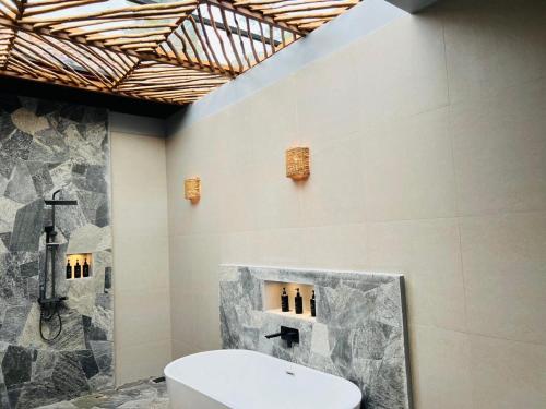 a bathroom with a white toilet and a shower at Eden Collection Thalpe in Talpe