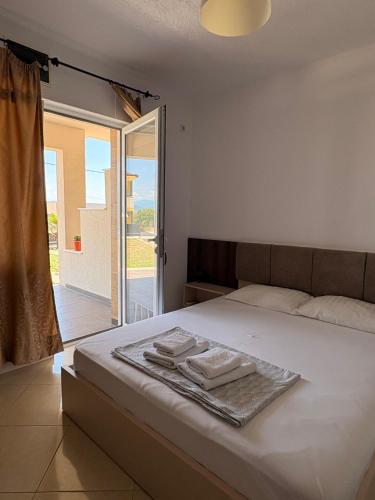 a bedroom with a bed with two towels on it at Vila Vavilon in Star Dojran