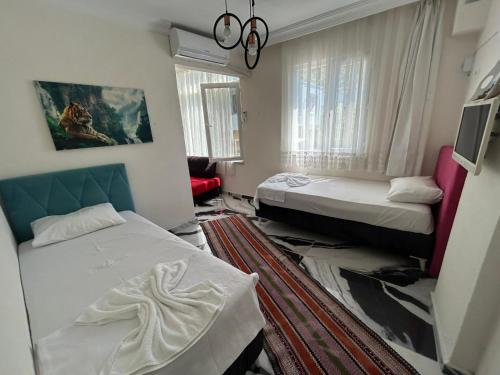 a hotel room with two beds and a living room at BEYAZEV Apart in Erdek