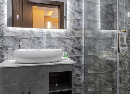 a bathroom with a sink and a mirror at BON Hotel Emporium in Ughelli