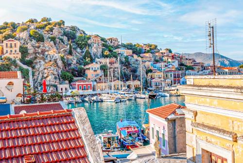 a view of a harbor with boats in the water at Kali Strata 2 - Downtown in Symi