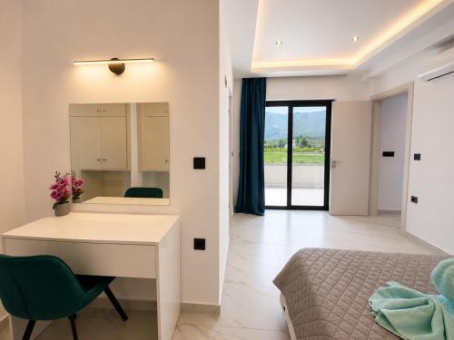 a white desk in a bedroom with a bed and a desk at Central Luxury Rooms in Alikanas