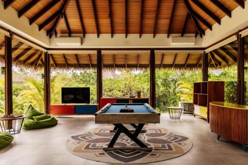 a pool table in the middle of a living room at Meliá Whale Lagoon Maldivas in Fenfushi