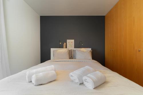 a bedroom with a large white bed with two pillows at Portimão, Praia da Rocha in Portimão