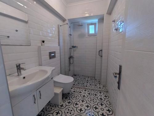 a bathroom with a sink and a toilet and a shower at Göcek Selya Hotel in Göcek