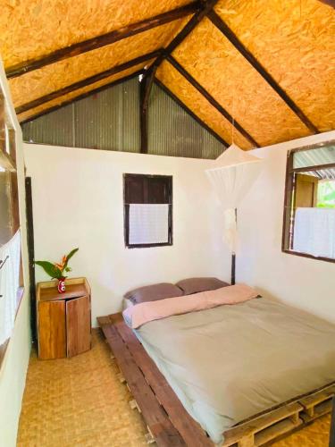 a bedroom with a large bed in a room at Banana garden in Pai