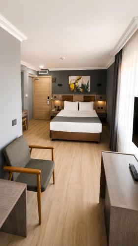 a large bedroom with a bed and a couch and a chair at Ankara Royal Hotel in Ankara