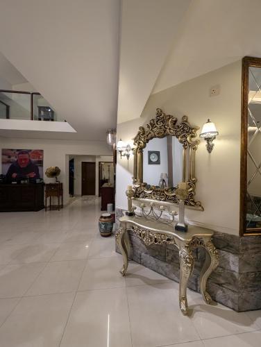 a large mirror and a bench in a room at Family's penthouse in Dhaka