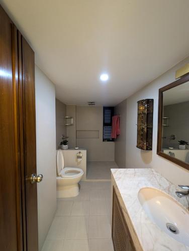a bathroom with a sink and a toilet at Family's penthouse in Dhaka
