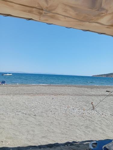 a person on a beach with the ocean in the background at Dream in Kamáres