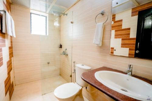 a bathroom with a toilet and a sink at The Mint Calangute in Calangute