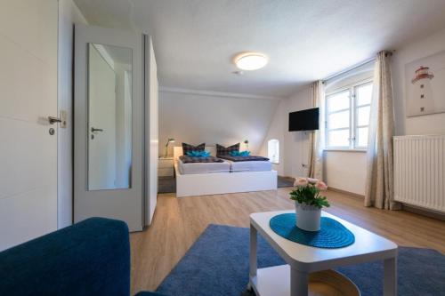 a living room with a couch and a table at FeWo-Dierhagen in Prerow