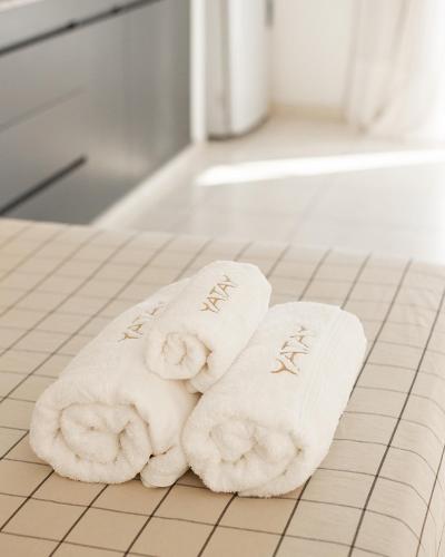 two towels on a tiled floor in a bathroom at Yatay in Goya